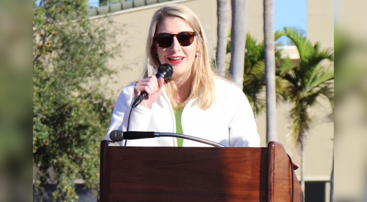 a woman speaking at a podium