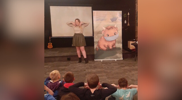 a speaker in front of an audience of children