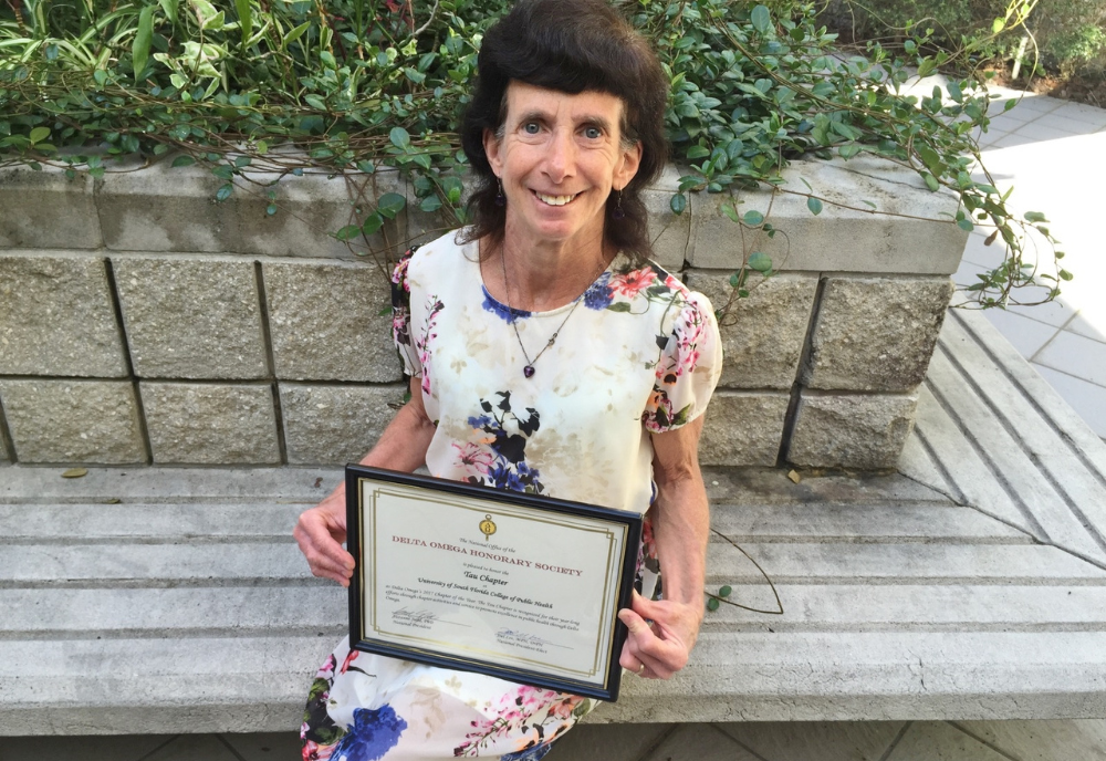 woman holding award