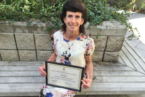 woman holding award