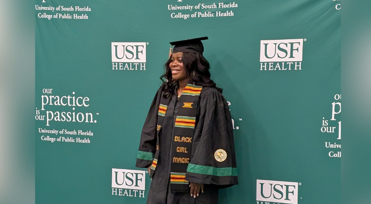 a graduate smiling in cap and gown