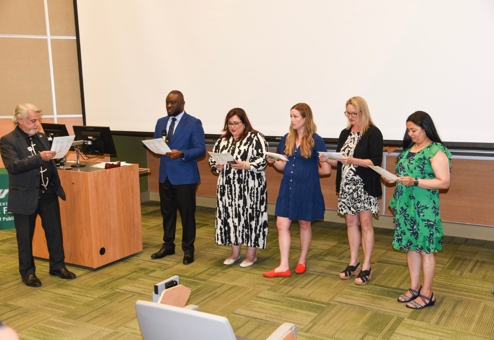 a group of people reading from a paper