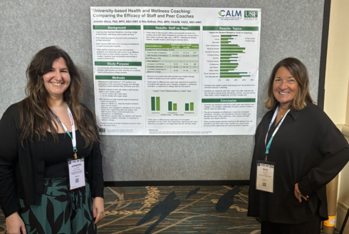 two women in front of poster