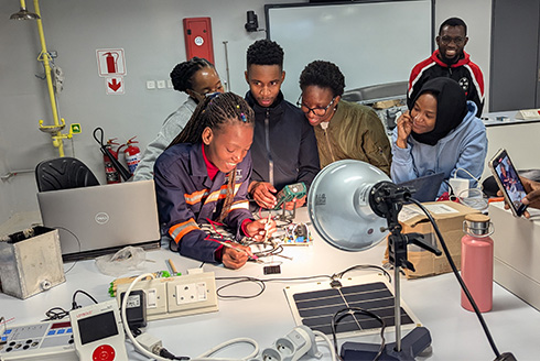 group of children in front of lab equipment