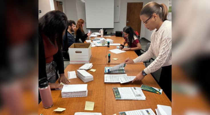 people sorting papers at a table