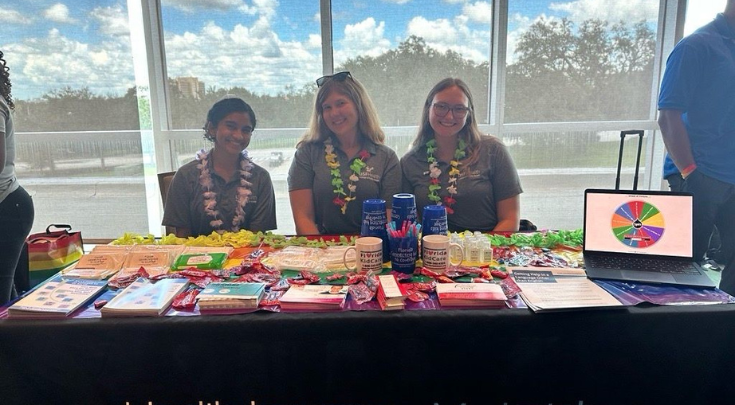 three women at tabling event