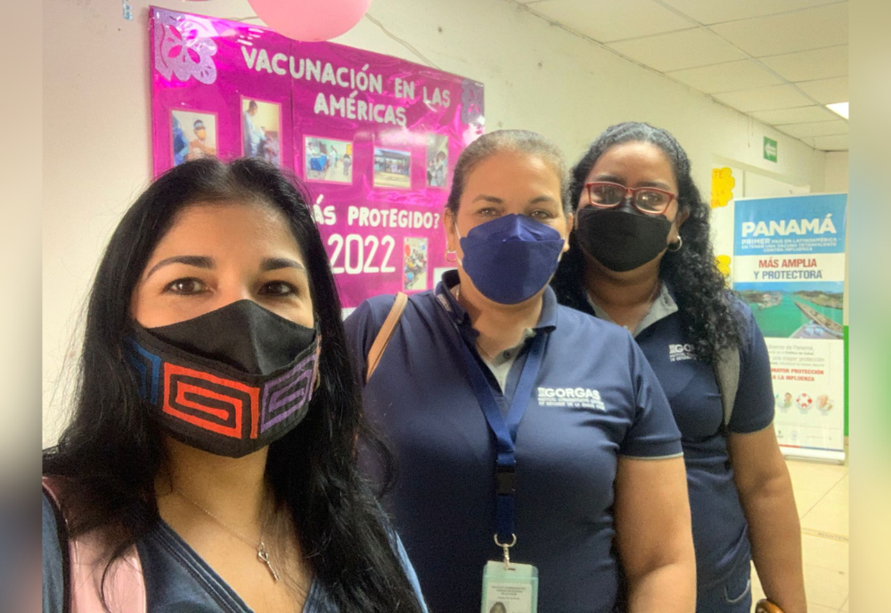 three people wearing masks