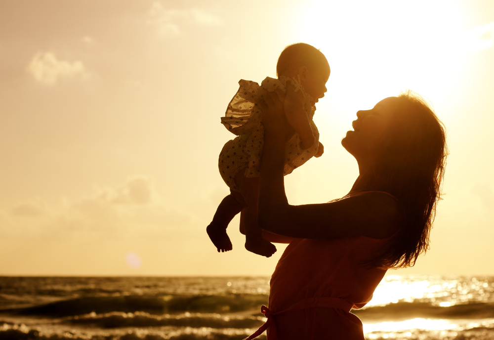 mother and baby on beach