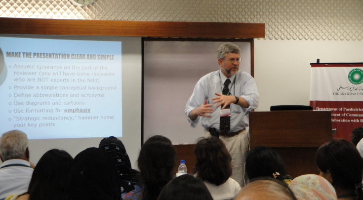 a person speaking to a classroom