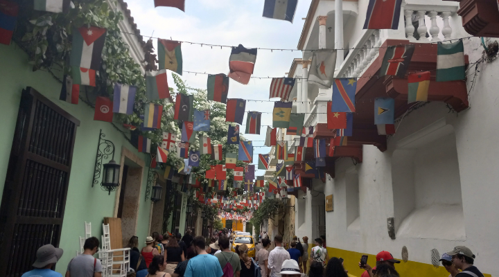 Image of a busy street in Colombia decorated with flags