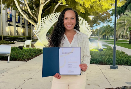 photo of daniela vasquez holding the gold humanism honor society certificate