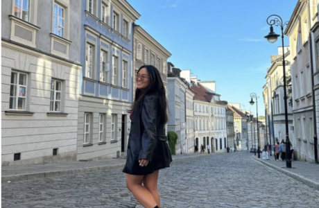 Honors student smiles in the cobblestone streets of Europe.