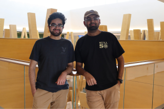 Tehami Ammad and Lalith Roopesh smile in the Judy Genshaft Honors College building