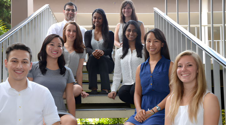 Honors alumni posed on stairwell