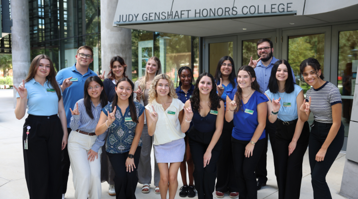 14 members of the Tampa Judy Genshaft Honors College Student Council pose outisde of the Honors building.