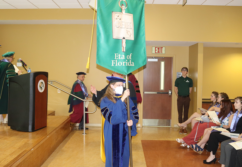 Person holds banner stating 'Eta of Florida'