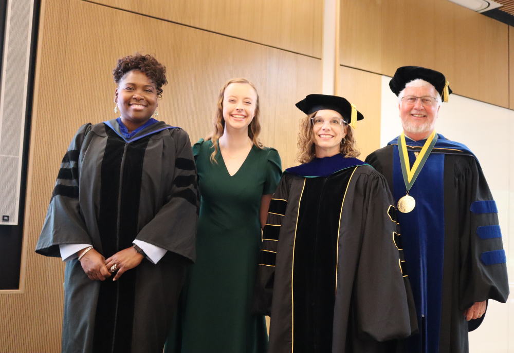 Dr. Sylvia Thomas, Honors student council president Audra Nikolajski, Dr. Lindy Davidson, and Dean Charles Adams smile at the Tampa Campus’s 2023 Honors Convocation Ceremony.