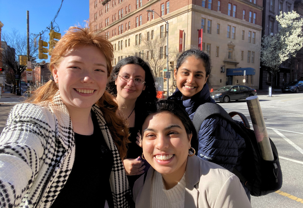 Four Honors students pose for a photo near the 2023 Johns Hopkins National Research Symposium.