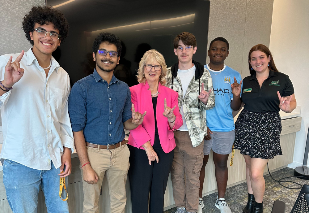 Dr. Susan MacManus smiles alongside a group of USF Honors students. 