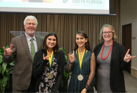 Sarasota-Manatee Honors Graduates posing with Honors Dean Charles Adams and Dr. Cayla Lanier