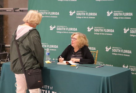 Dr. Cathleen Kaveny signs books for attendees