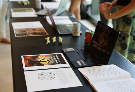 A table displaying physical copies of AI-enhanced student stories and graphic art
