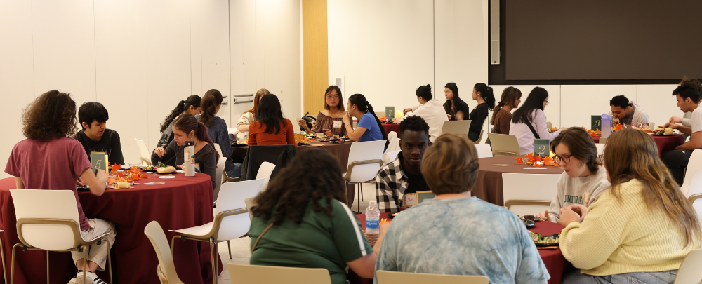 Tables in the Honors College forum are filled with students.