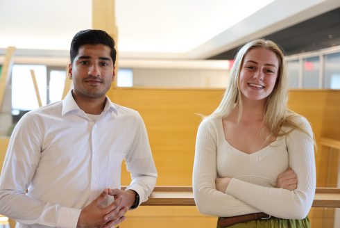 Judy Genshaft Honors College student leaders Abdul Muqeet Khawaja and Taylor Herman pose in the Judy Genshaft Honors College building