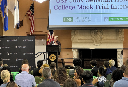 USF alum Maria Gerber speaks in front of a large audience at Stetson University of Law as part of the Judy Genshaft Honors College Summer Intensive Mock Trial program.