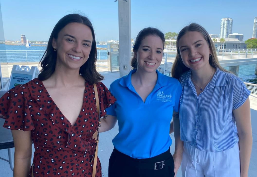 Marza Hiatt and two others smile while standing outdoors at the Honors Boating Breakfast. 