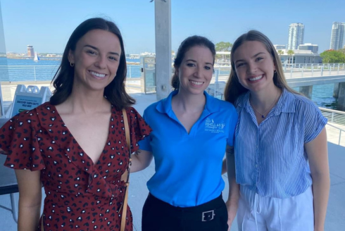 Marza Hiatt and two others smile while standing outdoors at the Honors Boating Breakfast. 