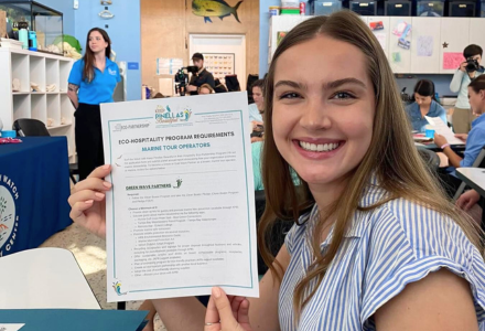 Marza Hiatt smiles while holding up a certificate.