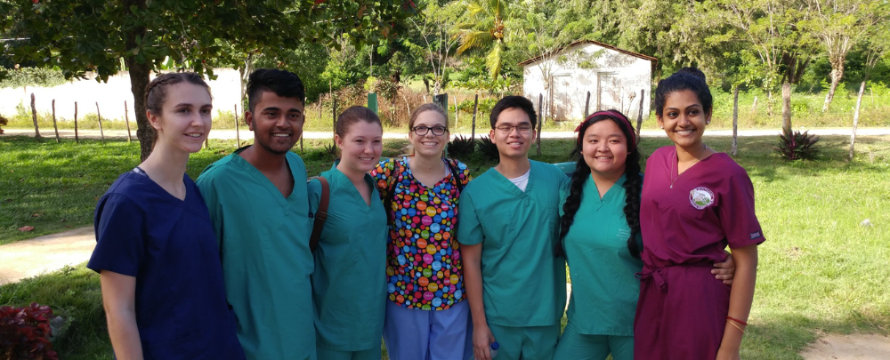 Nathan Le smiles with peers and Dr. Lindy Davidson in the Dominican Republic