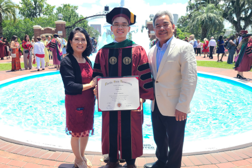 Nathan Le smiles with his parents at his graduation from Florida State University's College of Medicine