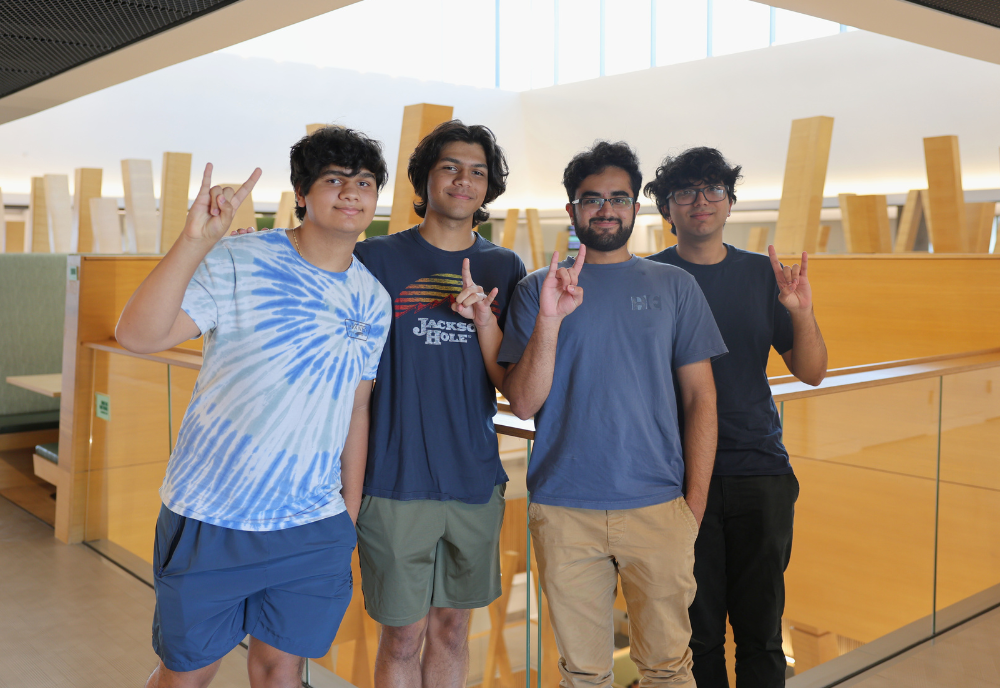 Jacob Delikat, Jude Delikat, Tehmani Ammad, and Muntahie Ammad posing in Honors Atrium