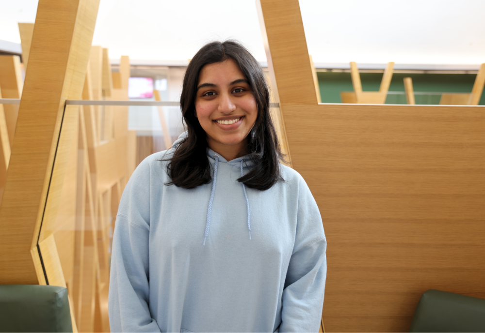 Headshot of Neha Dantuluri smiling in the Judy Genshaft Honors College building