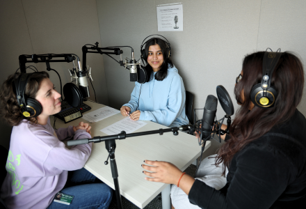 USF Judy Genshaft Honors College students chat with Neha Dantuluri in a recroding studio for an episode of the Honor Roll Podcast