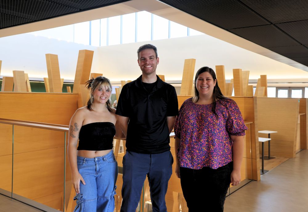 Honors student Nora Wolfgang, Dr. Matt King, and Honors advisor Megan Braunstein, and Requena smile in the Honors Atrium