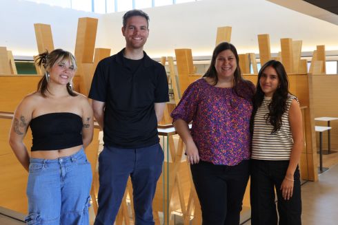 Honors student Nora Wolfgang, Dr. Matt King, and Honors advisor Megan Braunstein, and Requena smile in the Honors Atrium