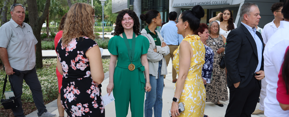 Honors students and families chat with staff and friends after the commencement ceremony