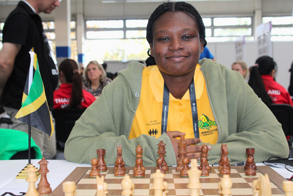 Judy Genshaft Honors College student Raehanna Brown sits in front of a chess board at the 2024 Chess Olympiad hosted in Budapest, Hungary.