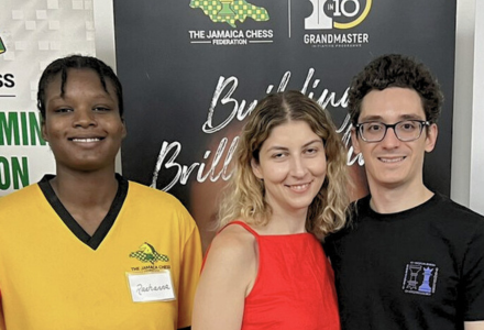 Raehanna Brown poses with Woman's Chess Grandmaster Tatev Abrahamyan and Men's Grandmaster Fabiano Caruana.