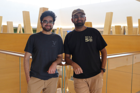 Tehami Ammad and Lalith Roopesh smile in the Judy Genshaft Honors College building