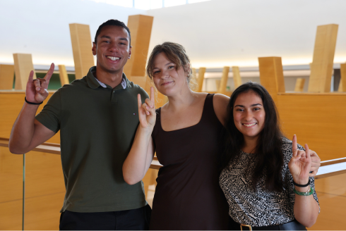 Judy Genshaft Honors College students Breno Nery Dantas, Jamie Powers, and Reva Gandhi pose while making 