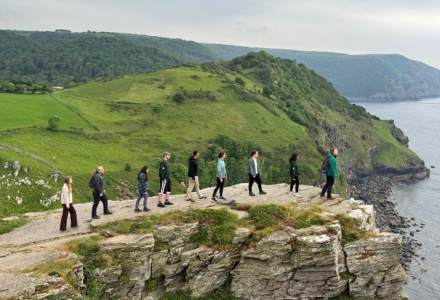 Nine memeber of the Judy Genshaft Honors College take in the spectacular views of southwest England on a cliff side near Exeter.