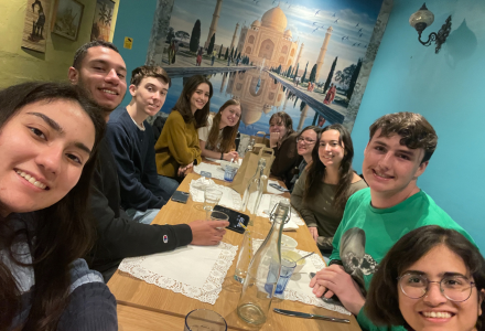 Nine Judy Genshaft Honors College students enjoy a meal together as part of the 2024 Semster in Exeter study abroad program