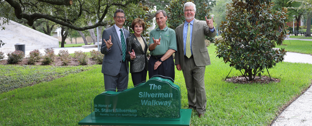 Dean Emeritus Silverman smiles with Steven Greenbaum, USF Presdient Emerita Judy Genshaft, and current Judy Genshaft Honors College Dean Charles Adams