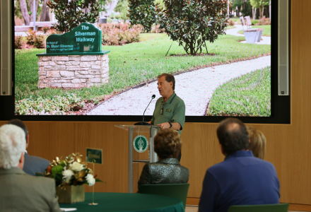 USF Honors Dean Emeritus Dr. Stuart Silverman speaks before a crowd at the dedication of the Silverman Walkway at the Judy Genshaft Honors College