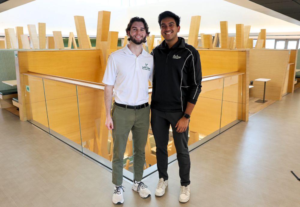 Parker Olive and Rahul Jain stand together on the fifth floor of the Honors building.