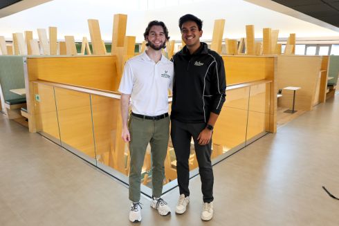 Parker Olive and Rahul Jain stand together on the fifth floor of the Honors building.